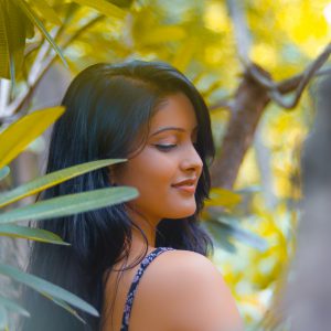 woman-standing-behind-trees-2913125