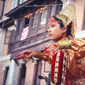 woman-wearing-yellow-and-red-traditional-dress-dancing-near-1274922